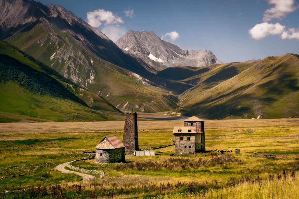 Landscape view of Caucasus mountains and stone houses and tower, Country of Georgia